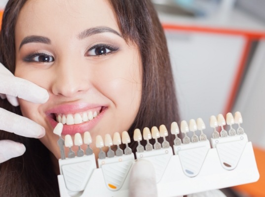 Young woman trying on dental veneers