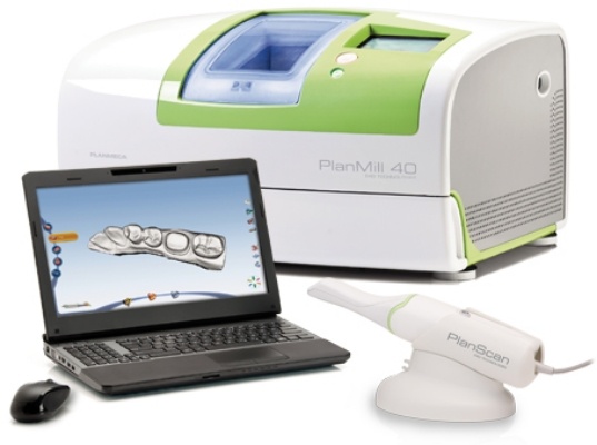 Handheld dental scanning system next to laptop computer