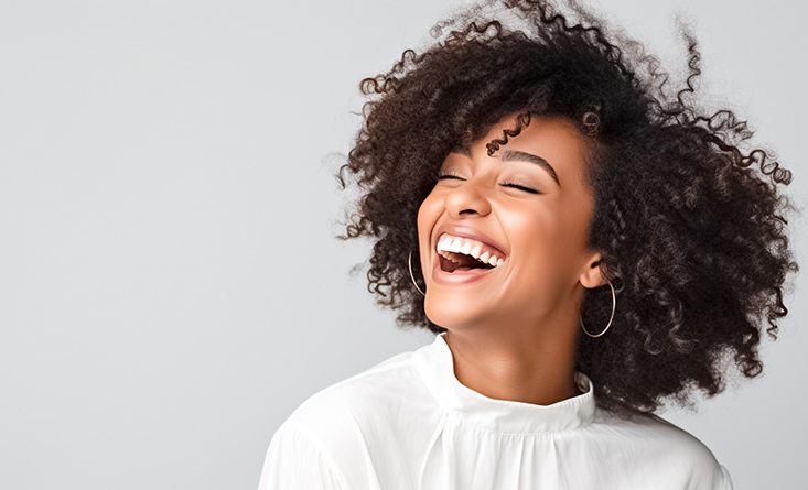 Woman with beautiful teeth smiling in white shirt