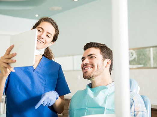 Dentist showing patient image on tablet